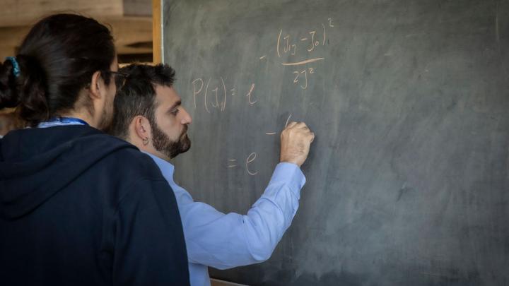 two scientists at blackboard